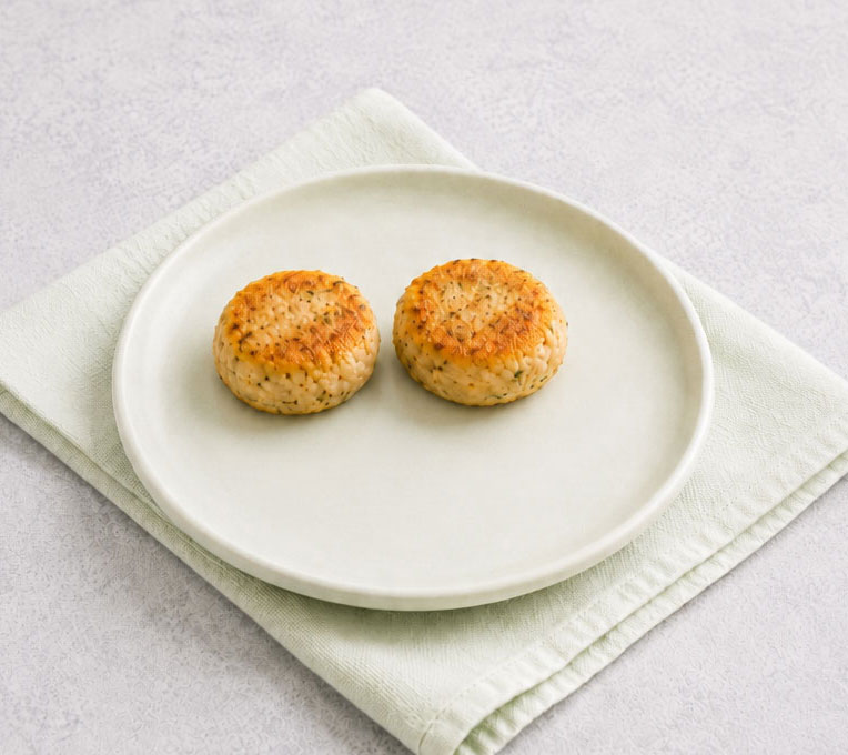 Two rice cakes on a white plate