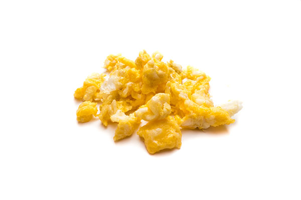 Scrambled eggs on a plain white background