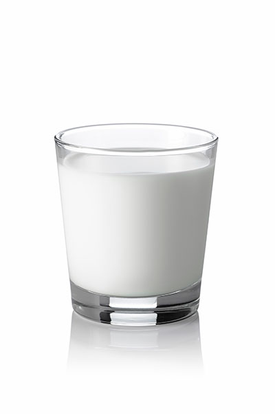 Glass of milk on white background