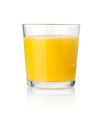 Glass of orange juice on white background