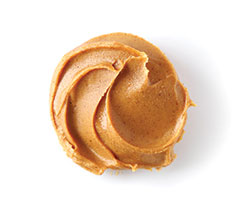Creamy peanut butter swirl on white background