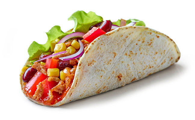 Taco filled with vegetables and ground meat
