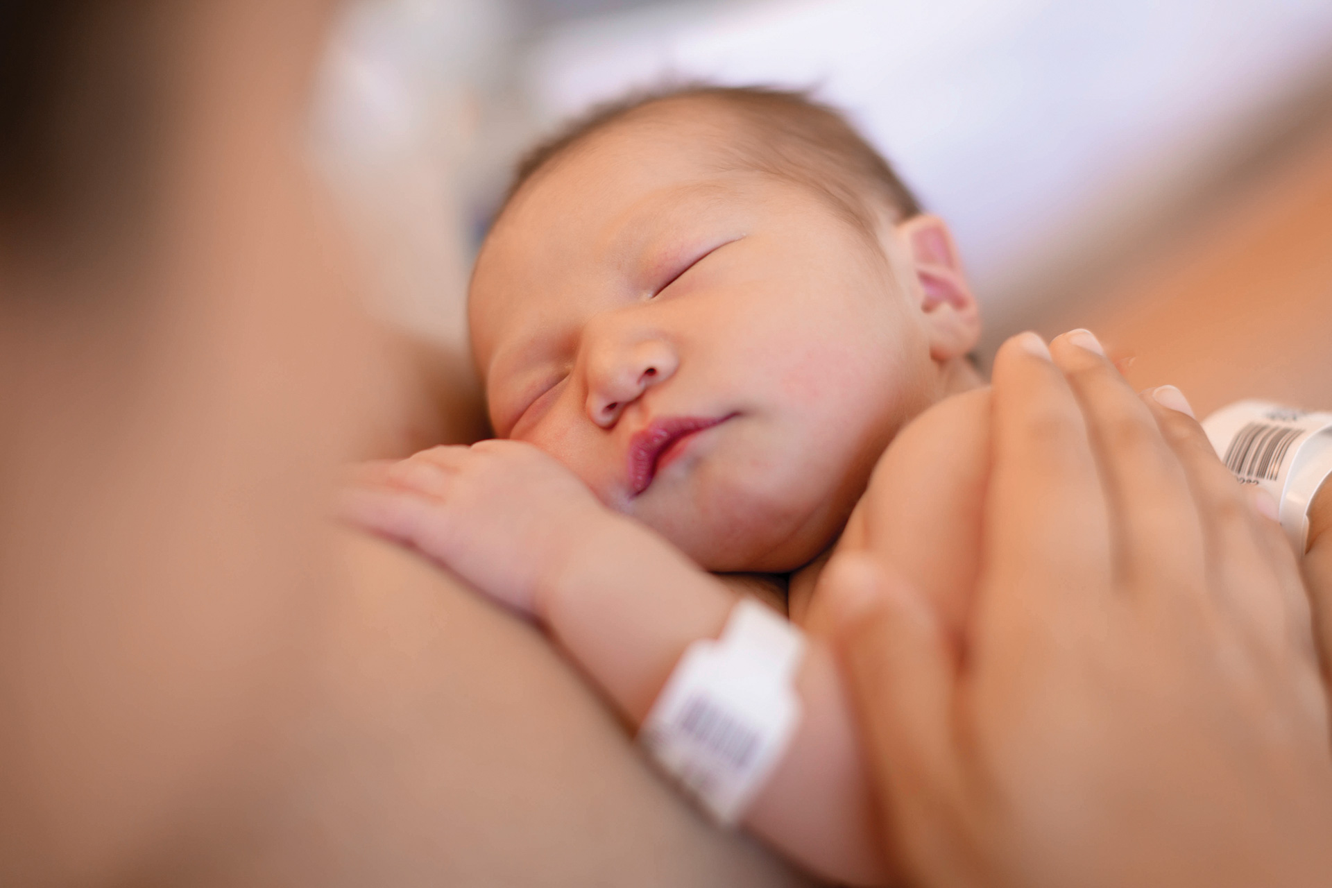 Sleeping Newborn Being Held